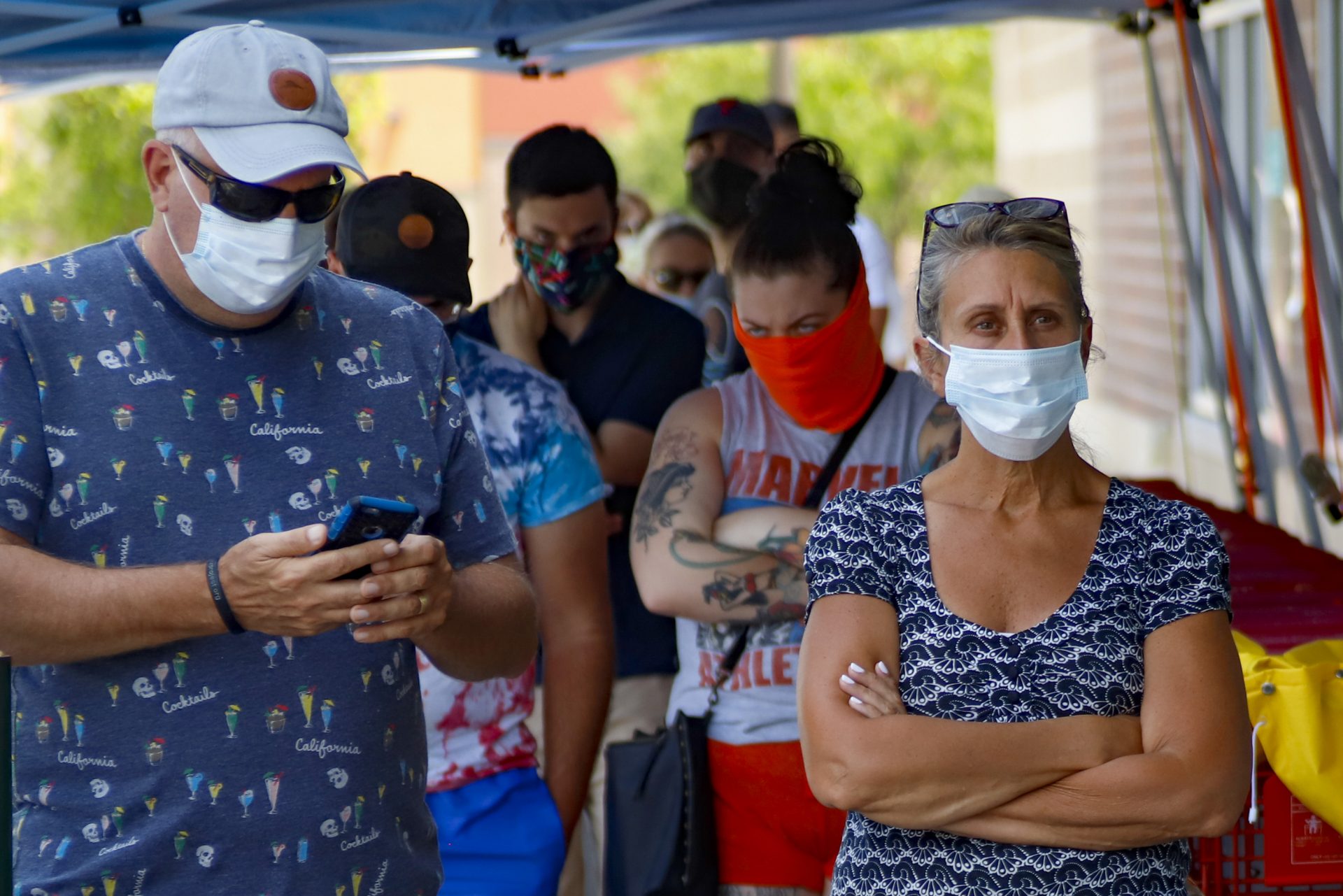 People waiting in line to enter a grocery store wear COVID-19 protective masks, Friday, July 3, 2020, in McCandless, Pa. Gov. Tom Wolf's more expansive mask order issued this week as the coronavirus shows new signs of life in Pennsylvania and the July Fourth holiday starts has been met with hostility from Republicans objecting to the Democrat's use of power or even to wearing a mask itself.