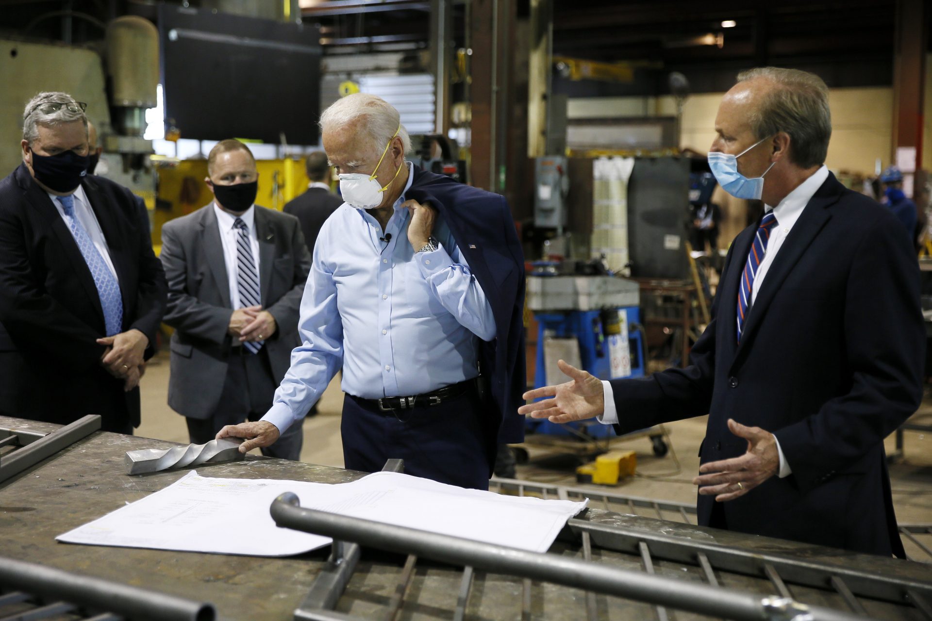 Democratic presidential candidate, former Vice President Joe Biden, center, listens to McGregor Industries owner Bob McGregor, right, give a tour of the metal fabricating facility, Thursday, July 9, 2020, in Dunmore, Pa.