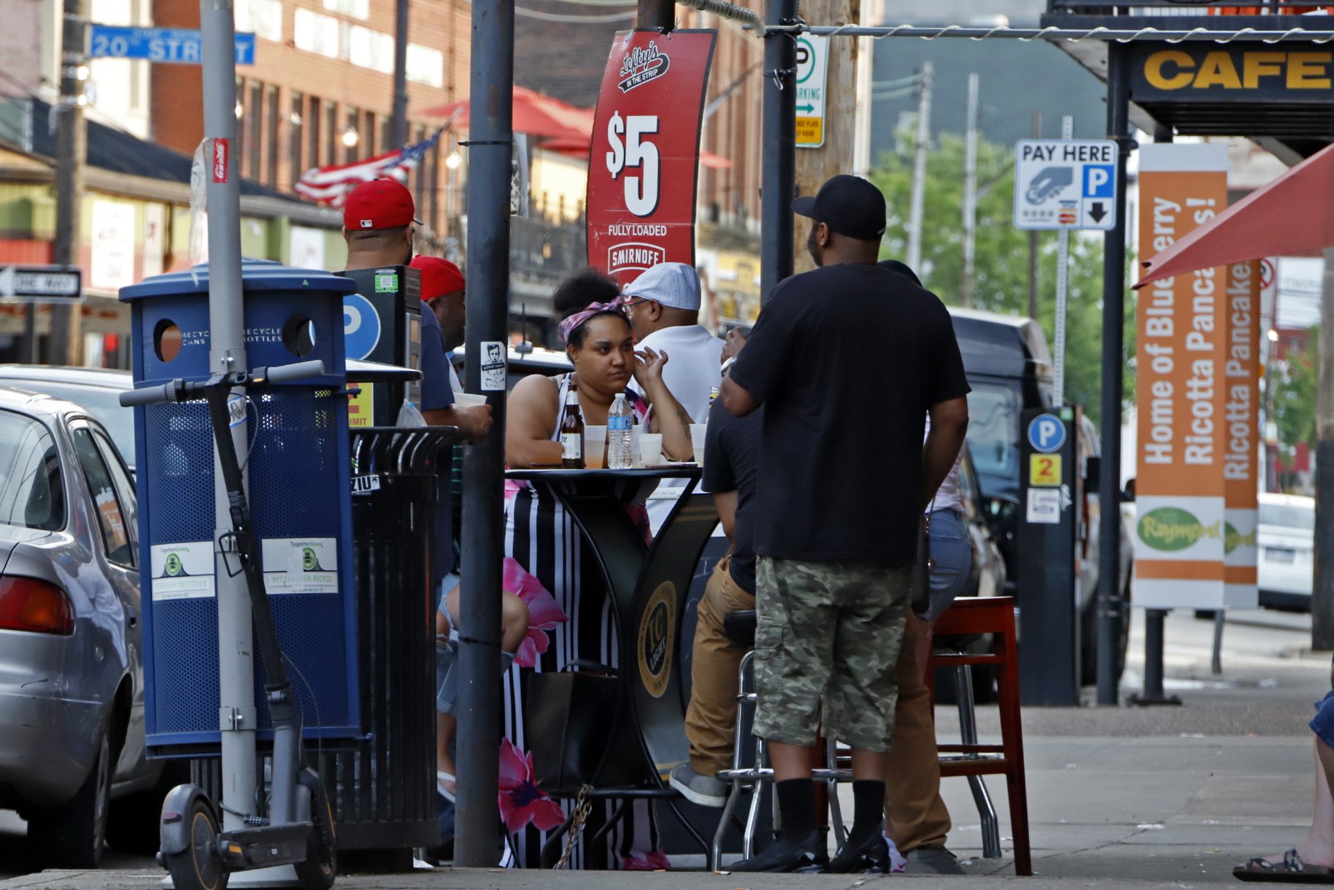People gather at tables outside Lefty's bar in the Strip District of downtown Pittsburgh Sunday, June 28, 2020.