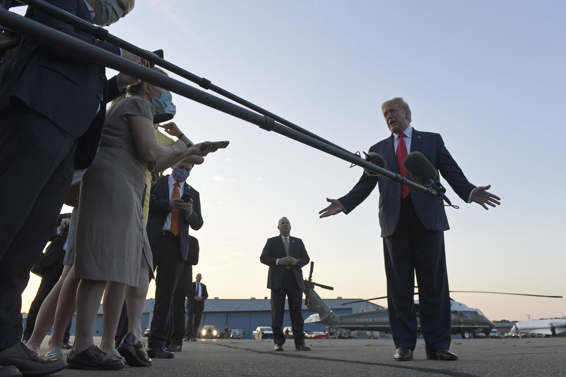 President Donald Trump talks with reporters before departing from Morristown Municipal Airport in Morristown, N.J., Sunday, Aug. 9, 2020. Trump is returning to Washington after spending the weekend at the Trump National Golf Club.