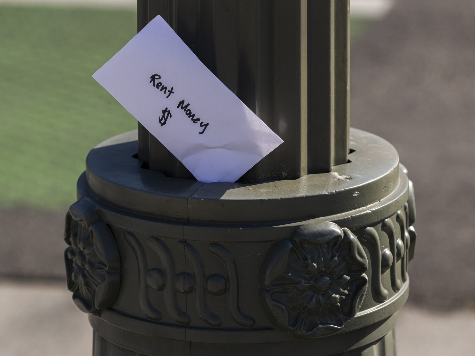 An envelope labeled "Rent Money" is left tucked in a lighting pole in Los Angeles on April 1. President Trump's new executive order to prevent evictions isn't enough and Congress needs to act, housing activists say.