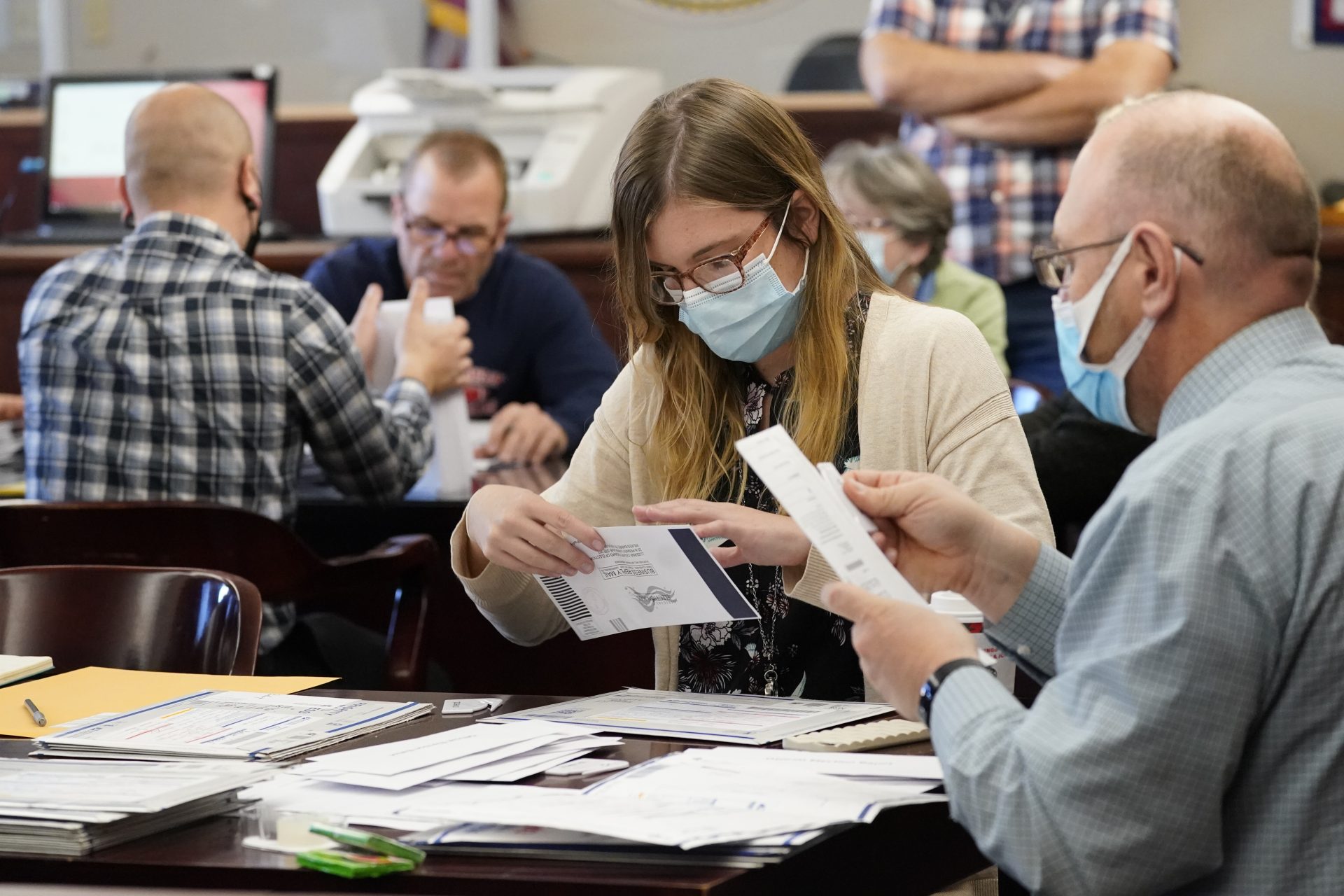 Luzerne County workers canvas ballots that arrived after closing of voting until Friday at 5 p.m. and postmarked by Nov. 3rd as vote counting in the general election continues, Friday, Nov. 6, 2020, in Wilkes-Barre, Pa.