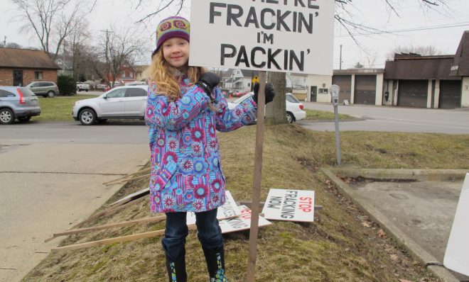 A young girl holds a sign at a rally in Butler County.