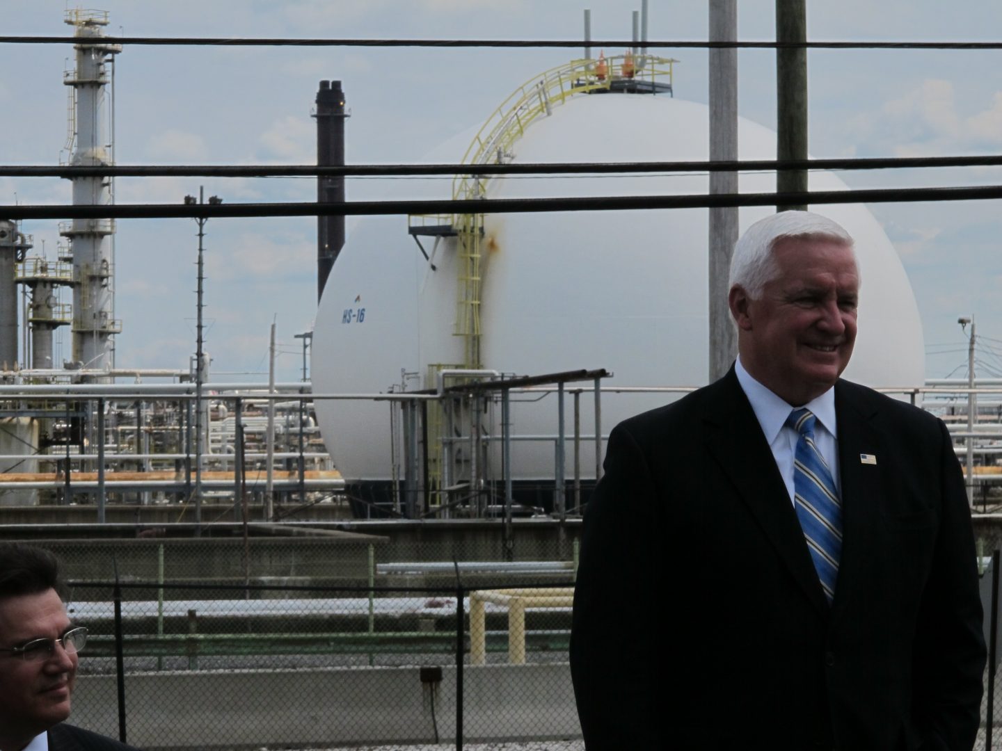 Gov. Tom Corbett stands in front of the shuttered Sunoco refinery in Marcus Hook, Delaware County.