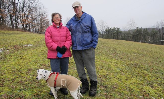 Marianne and Rick Atkinson with their dog Spot, on their property in Clearfield County.