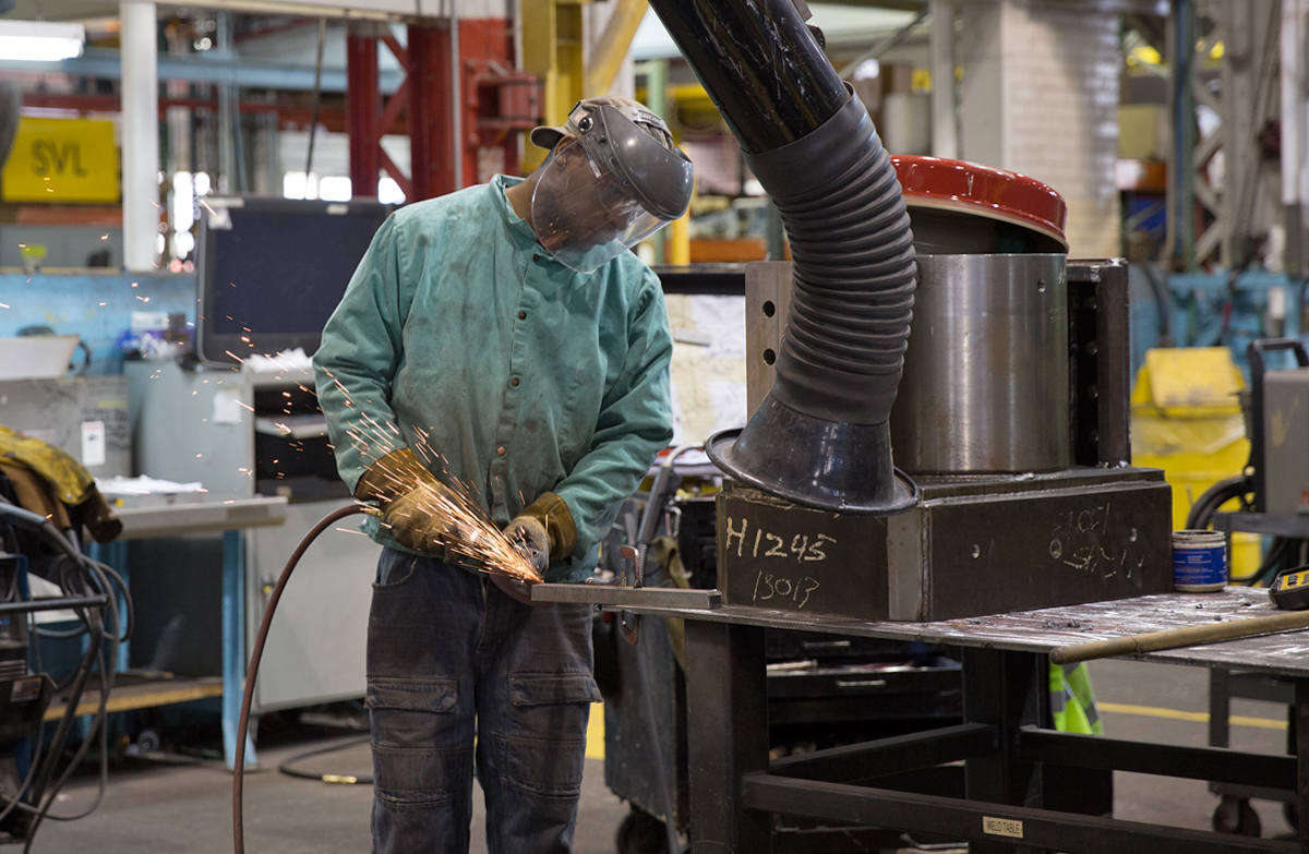 A welder works in the warehouse at Schramm, Inc. headquarters in West Chester, Pa.