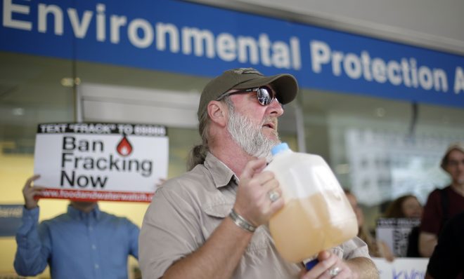 Ray Kemble of Dimock, displays a jug of what he identifies as his contaminated well water in this August 2013 file photo.  