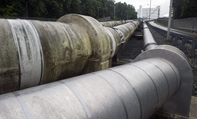 Transfer pipes carry liquified natural gas to and from a holding tank, seen in background, at Dominion Energy's Cove Point LNG Terminal in Lusby, Md., Thursday, June 12, 2014. 