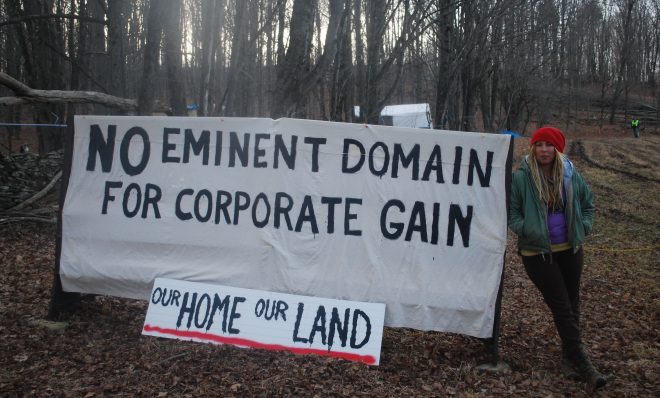 Megan Holleran stands by a sign on her family's land, March, 2016. The Hollerans lost their court battle to save their maple trees from eminent domain seizure. The trees were cut to make way for the Constitution Pipeline, which had been stalled amid legal battles until Williams withdrew the project in February.