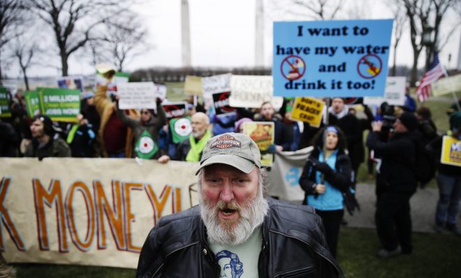 Fracking opponents, including Ray Kemble of Dimock, Pa., front, demonstrate before Governor-elect Tom Wolf takes the oath of office to become the 47th governor of Pennsylvania, Tuesday, Jan. 20, 2015, at the state Capitol.