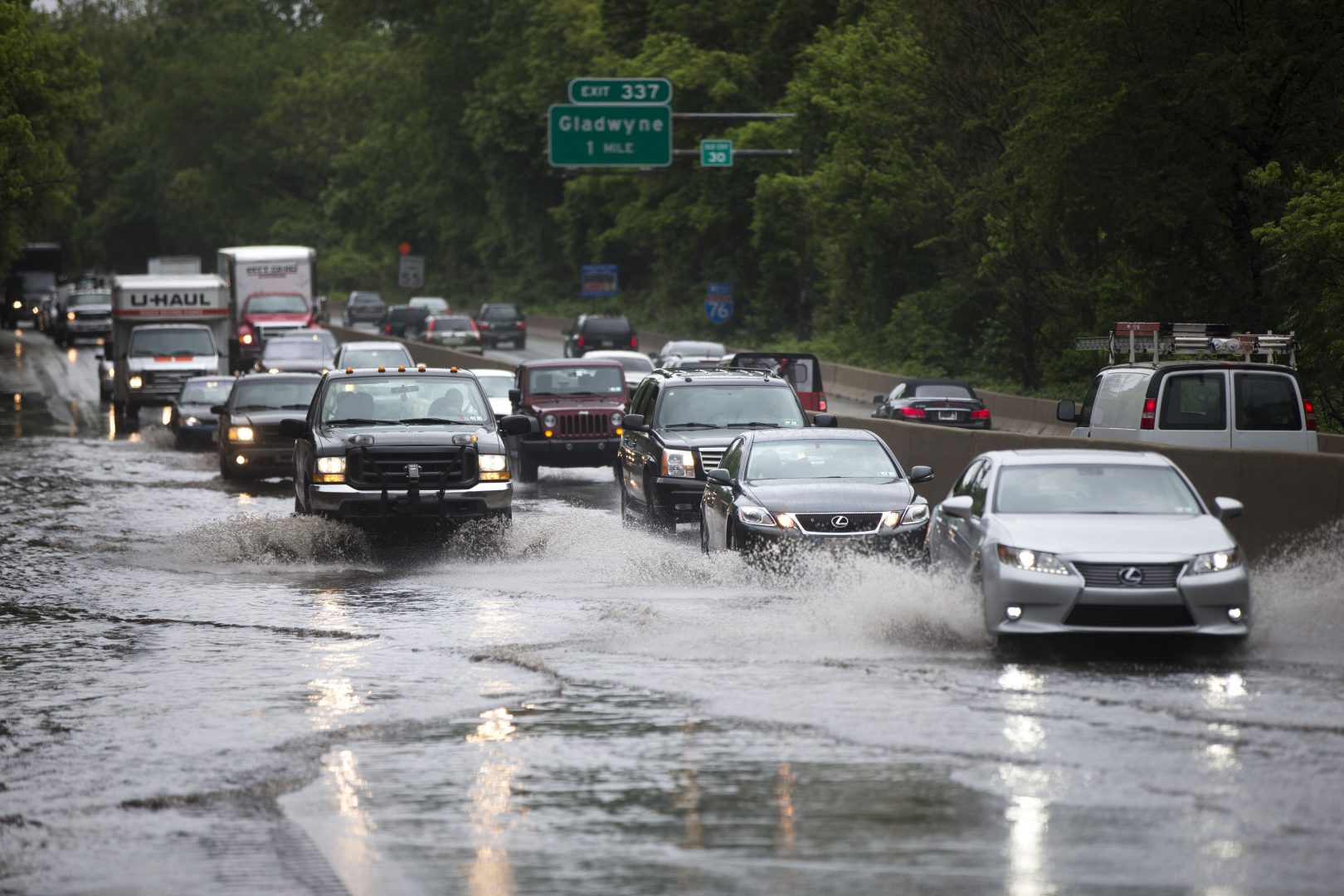 In this 2014 photo, vehicles pass through a flooded section of eastbound Interstate 76 near the Gladwyne exit. Climate scientists say the Pennsylvania can expect more precipitation as global warming continues. 