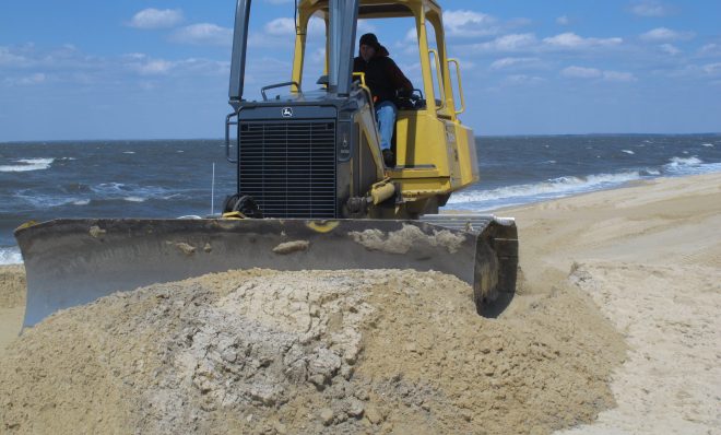 A front-end loader moves sand on Delaware Bay Beach in Middle Township, NJ that was badly eroded by Superstorm Sandy. 