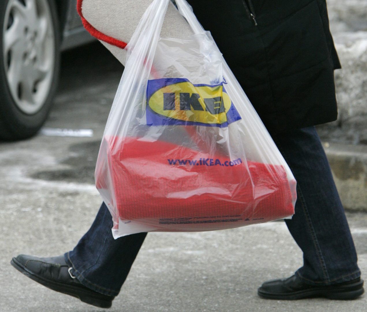 A customer totes a shopping bag outside an Ikea store in Conshohocken, Pa., on Tuesday, Feb. 20, 2007. The Swedish retailer, which has its U.S. headquarters in suburban Conshohocken, announced Tuesday that it will start charging customers a nickel for 