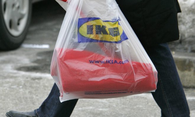 A customer totes a shopping bag outside an Ikea store in Conshohocken, Pa., on Tuesday, Feb. 20, 2007. The Swedish retailer, which has its U.S. headquarters in suburban Conshohocken, announced Tuesday that it will start charging customers a nickel for 