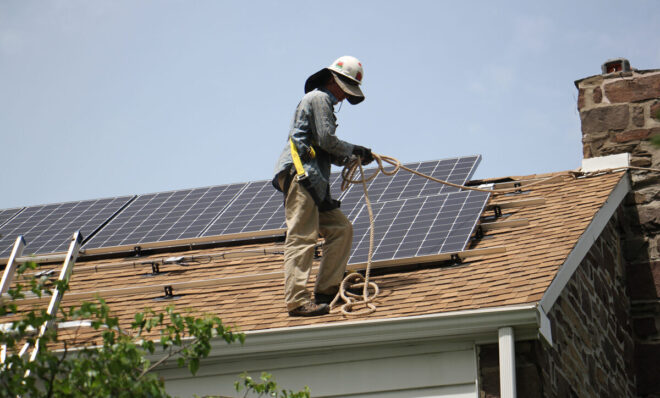 In this photo from May 2017, Patrick Whittaker of Solar States installs solar panels on the roof of a home in Bryn Mawr, Pa. 