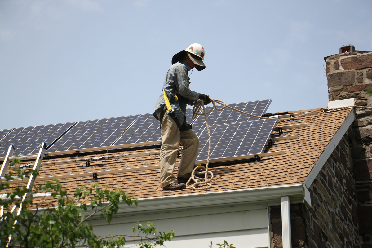 In this photo from May 2017, Patrick Whittaker of Solar States installs solar panels on the roof of a home in Bryn Mawr, Pa. 