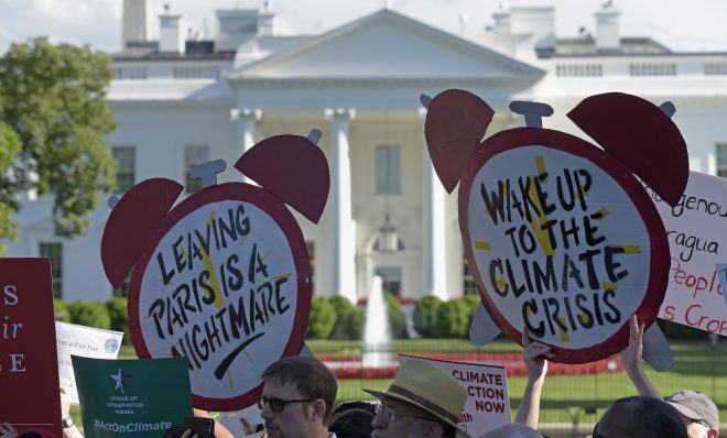 Protesters gather outside the White House in Washington, Thursday, June 1, 2017, to protest President Donald Trump's decision to withdraw the Unites States from the Paris climate change accord.