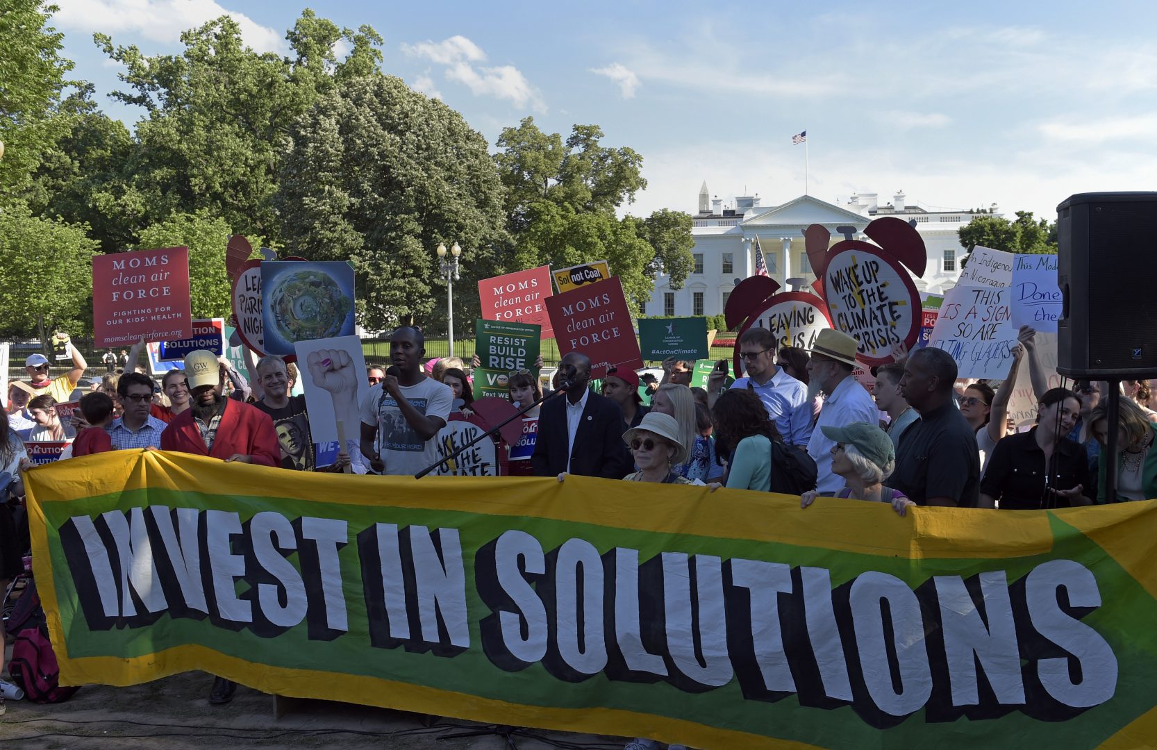 Activists gather outside the White House in Washington, Thursday, June 1, 2017, to protest President Donald Trump's decision to withdraw the Unites States from the Paris climate change accord.