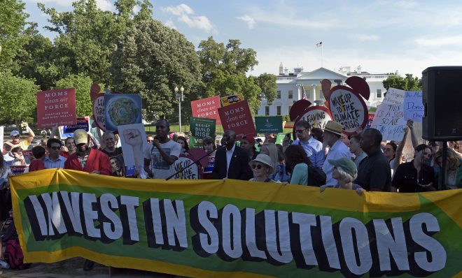 Activists gather outside the White House in Washington, Thursday, June 1, 2017, to protest President Donald Trump's decision to withdraw the Unites States from the Paris climate change accord.