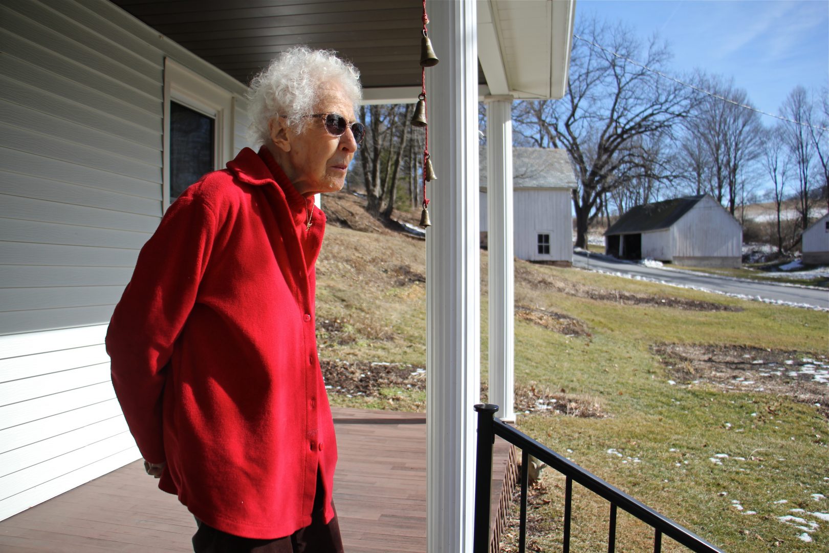 From the porch of her Palmerton farmhouse, Albertine Anthony looks out on the rolling hills of lower Carbon County. She believes the PennEast pipeline's proposed route through her 124-acre farm threatens her water supply. (Emma Lee/WHYY)