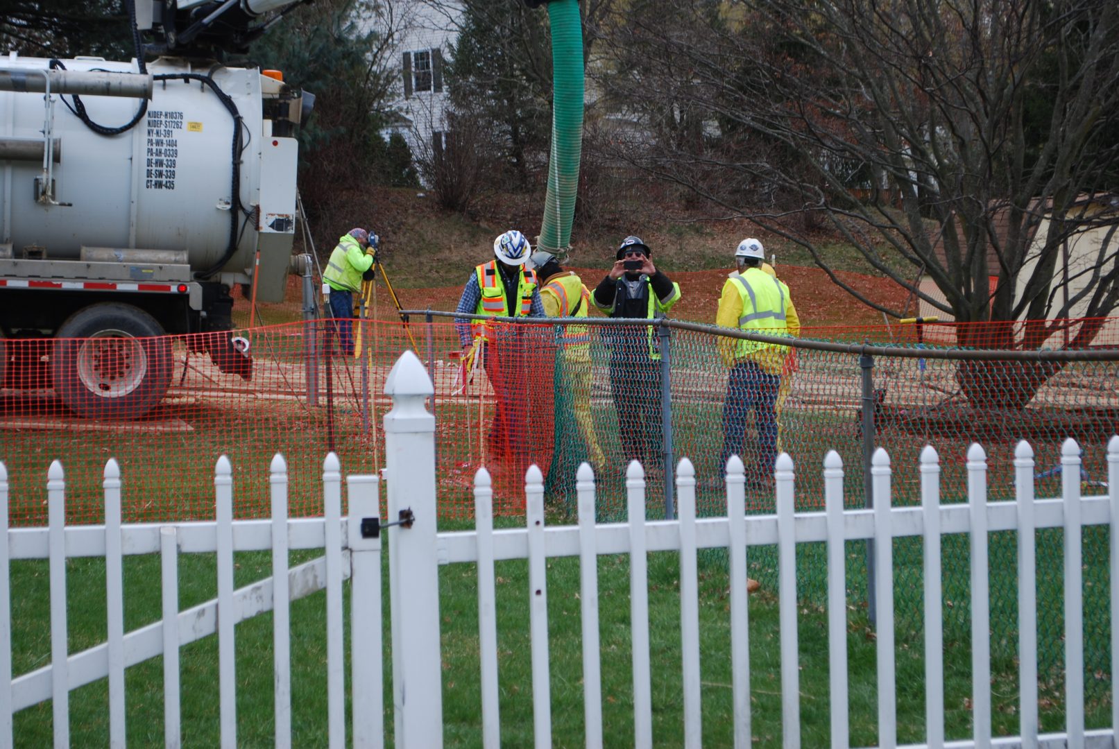 In this May 2018 photo, workers and contractors for Sunoco Pipeline investigate sink holes behind homes at Lisa Drive, West Whiteland Township, Chester County where the company has been drilling for construction of the Mariner East 2 and 2X pipelines. In the photo, a security guard is taking a picture of the reporter.
