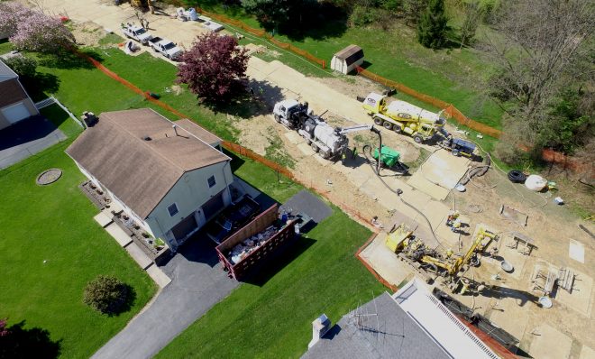 In this photo from May 2018, Mariner East 2 pipeline construction crews work in the backyards of homes on Lisa Drive in West Whiteland Township, Chester County. The area has dealt with a number of sinkholes, including one on July 6, 2023. The problem led to Energy Transfer buying at least five homes along Lisa Drive after the aquifer there was damaged.