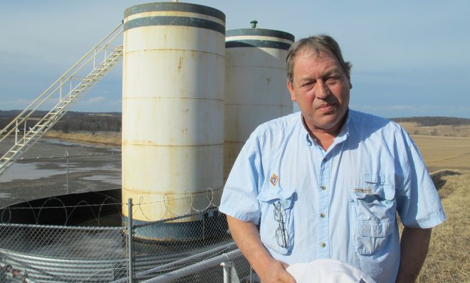 Jim Barrett stands next to a wellpad on his farm in Bradford County. He says Chesapeake Energy, which drilled four natural gas wells on his land, is cheating him out of royalty money. He is part of a class-action lawsuit against the company, which is separate from a case involving Chesapeake that's being pursued by the state Attorney General.