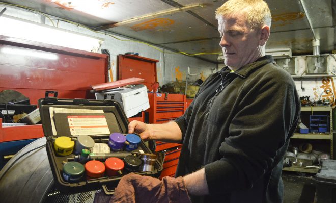 Scott Reynolds, owner of Express Transmission in Beaver County, shows an array of gas cap adapters. The adapters are used as a part of Pennsylvania's vehicle emission testing program.