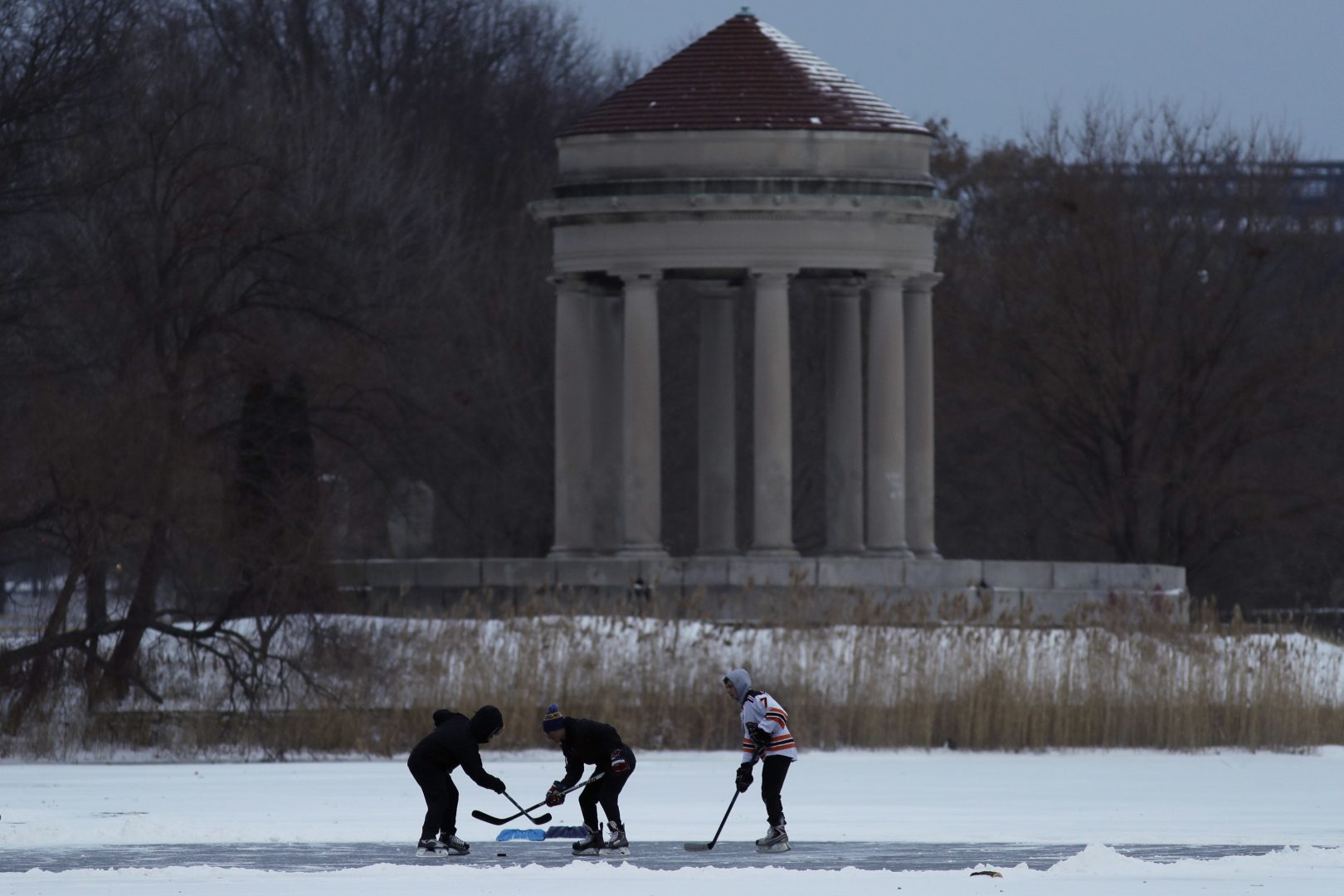 Youths play ice hockey on a frozen pond at Franklin Delano Roosevelt Park during a winter storm, Thursday, Jan. 4, 2018, in Philadelphia. (AP Photo/Matt Slocum)