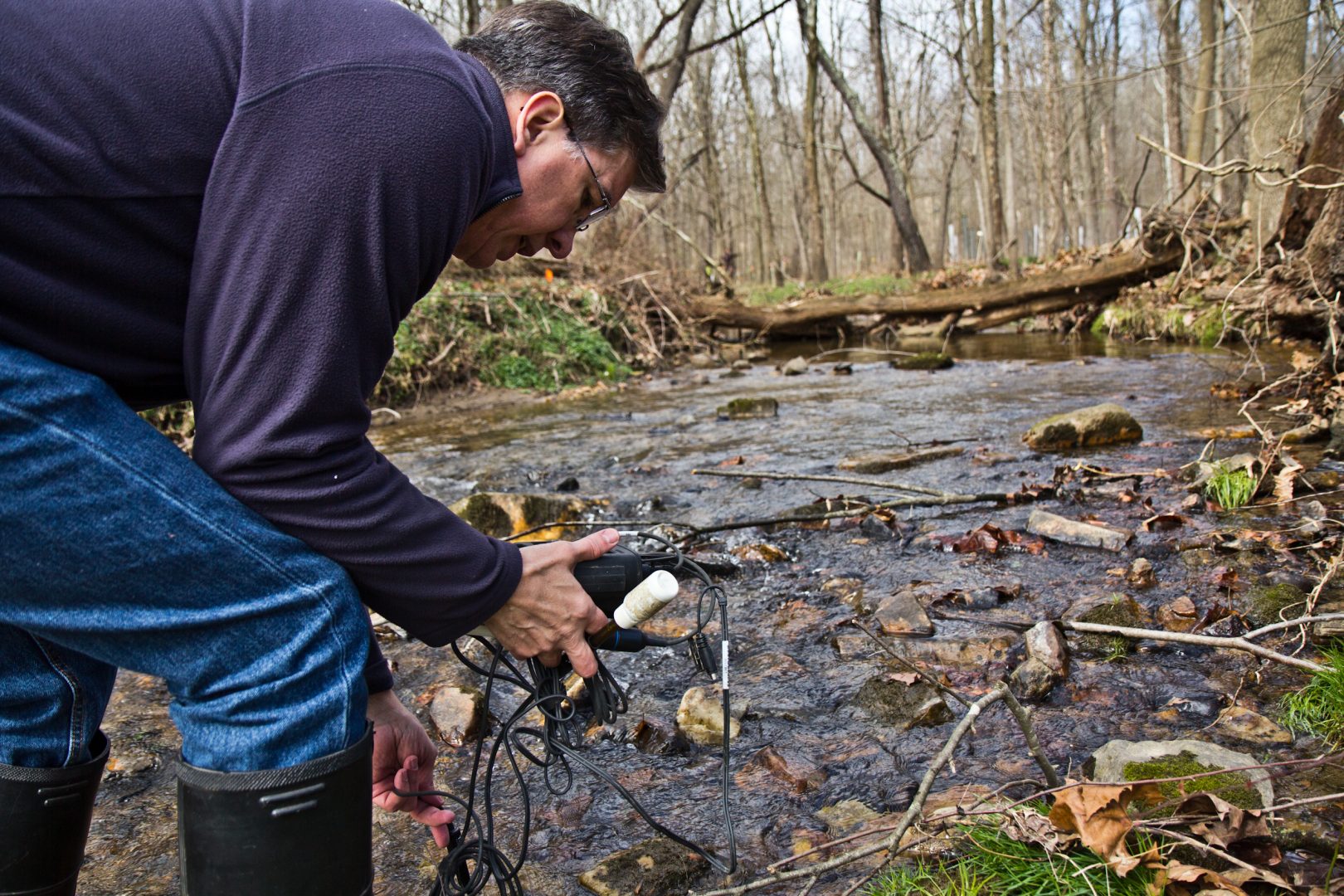 John Jackson, senior research scientist at the Stroud Water Research Center, measure conductivity in the White Clay Creek stream.