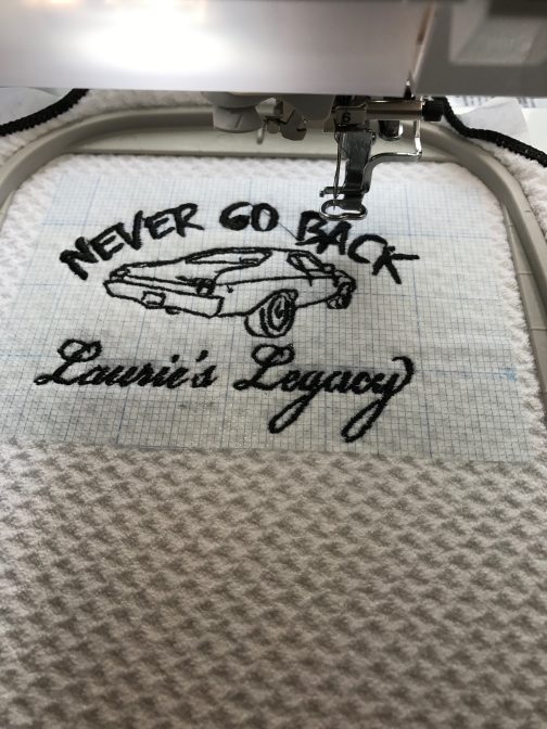 Karen Kuykendall Nordsick stitched "Never Go Back" onto a golf towel as part of a fundraiser for domestic violence.