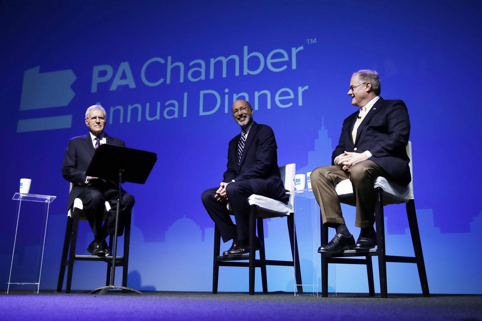 Alex Trebek, left, moderates a gubernatorial debate between Democratic Gov. Tom Wolf, center, and Republican Scott Wagner in Hershey, Pa., Monday, Oct. 1, 2018. The debate is hosted by the Pennsylvania Chamber of Business and Industry. 