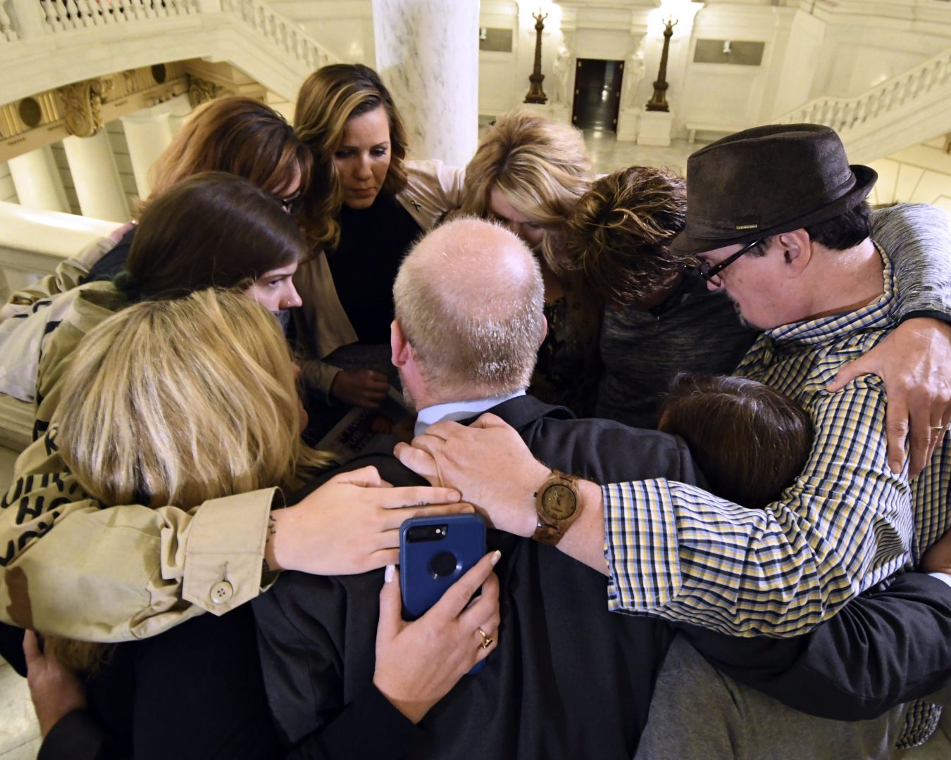 Survivors of child sexual abuse hug in the Pennsylvania Capitol while awaiting legislation to respond to a landmark state grand jury report on child sexual abuse in the Roman Catholic Church, Wednesday, Oct. 17, 2018 in Harrisburg, Pa.