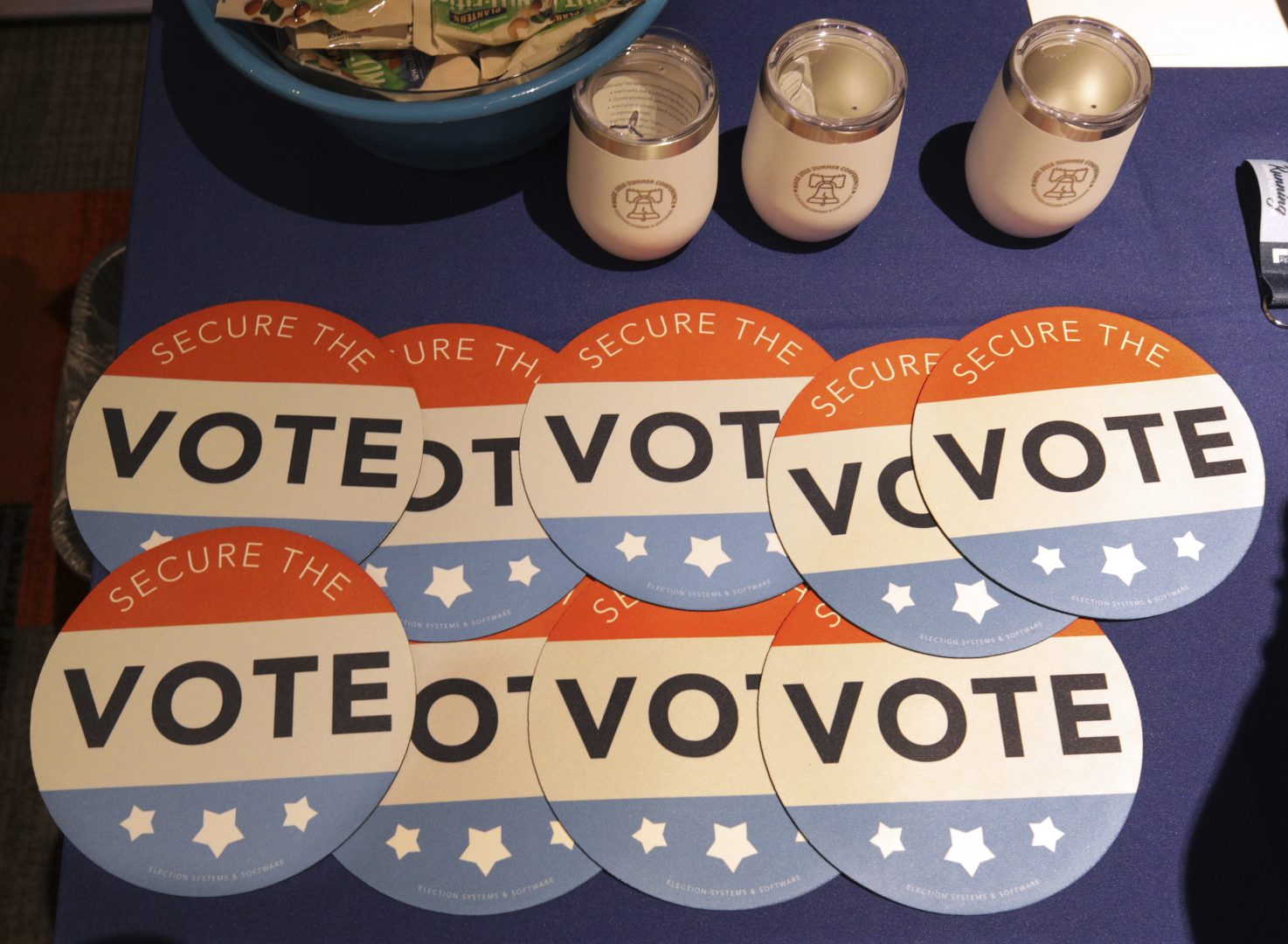 Computer mouse pads with Secure the Vote logo on them are seen on a vendor's table at a convention of state secretaries of state Saturday, July 14, 2018, in Philadelphia.