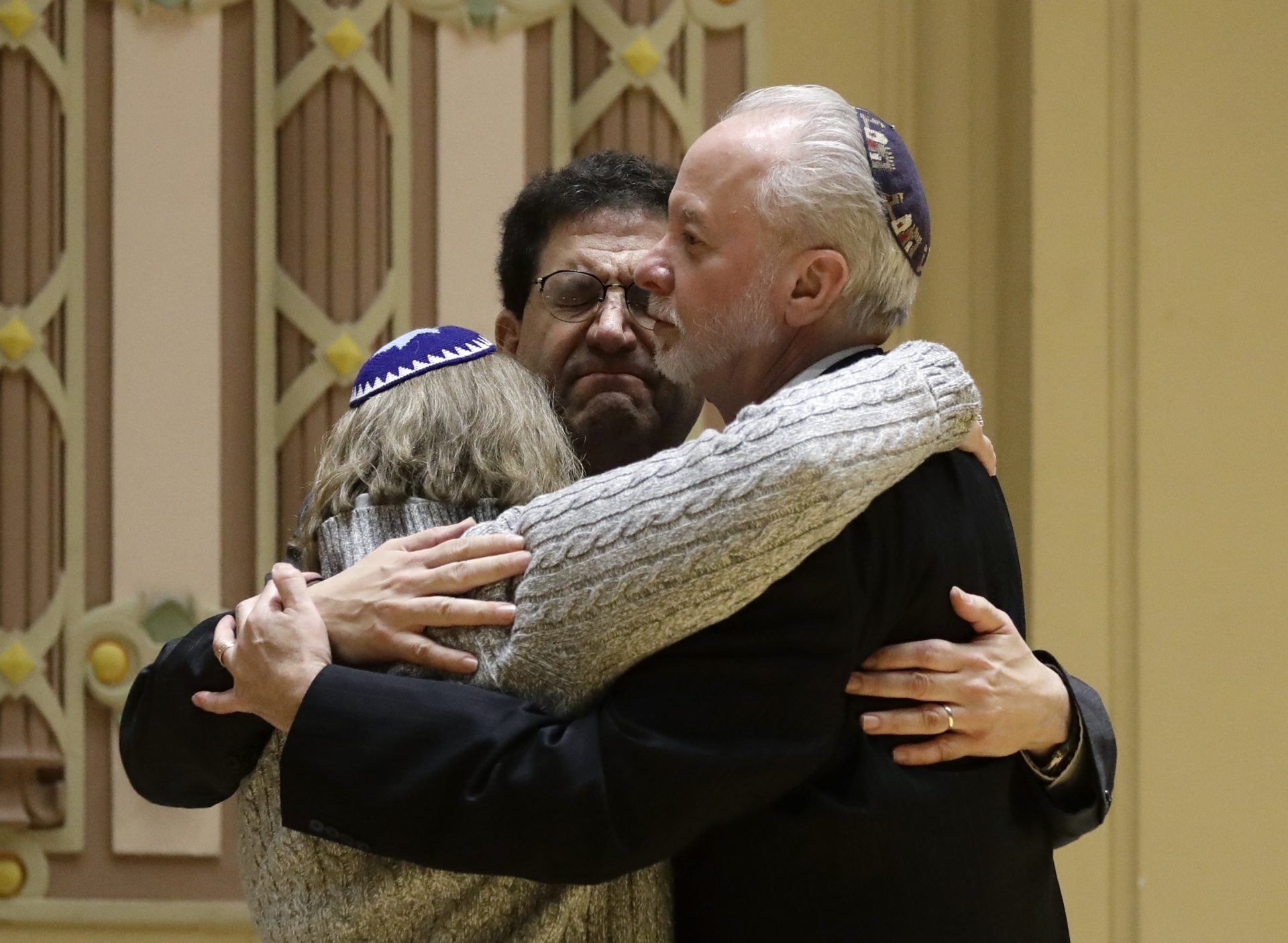 FILE PHOTO: Rabbi Jeffrey Myers, right, of Tree of Life/Or L'Simcha Congregation hugs Rabbi Cheryl Klein, left, of Dor Hadash Congregation and Rabbi Jonathan Perlman during a community gathering held in the aftermath of a deadly shooting at the Tree of Life Synagogue in Pittsburgh, Sunday, Oct. 28, 2018.