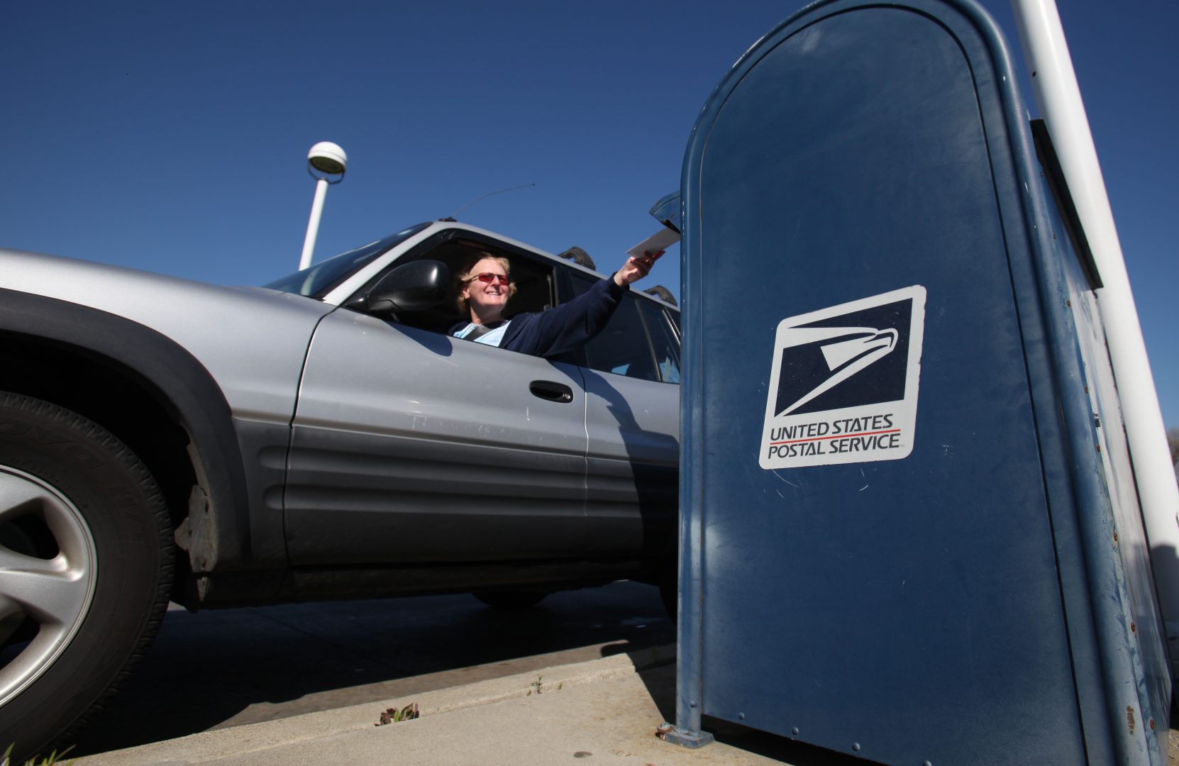 FILE PHOTO: In this photo taken Feb. 24, 2012, mail is deposited into an outdoor postal box at the Sacramento Processing Center in West Sacramento, Calif. 