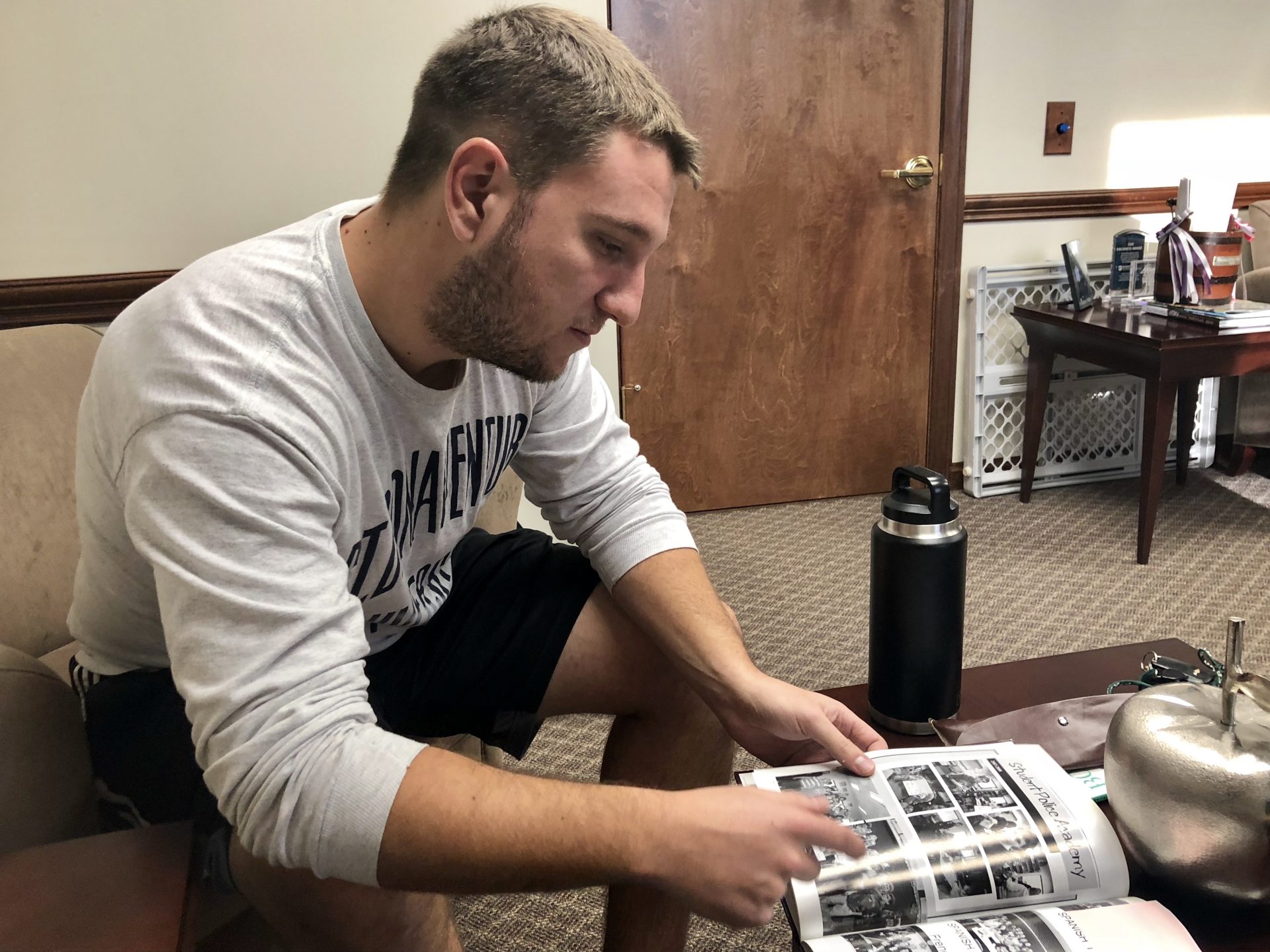 Grant Mundy, who went to school with Dylan Elchin, looks at old yearbooks photos in a Beaver Area School District office on Dec. 13, 2018.