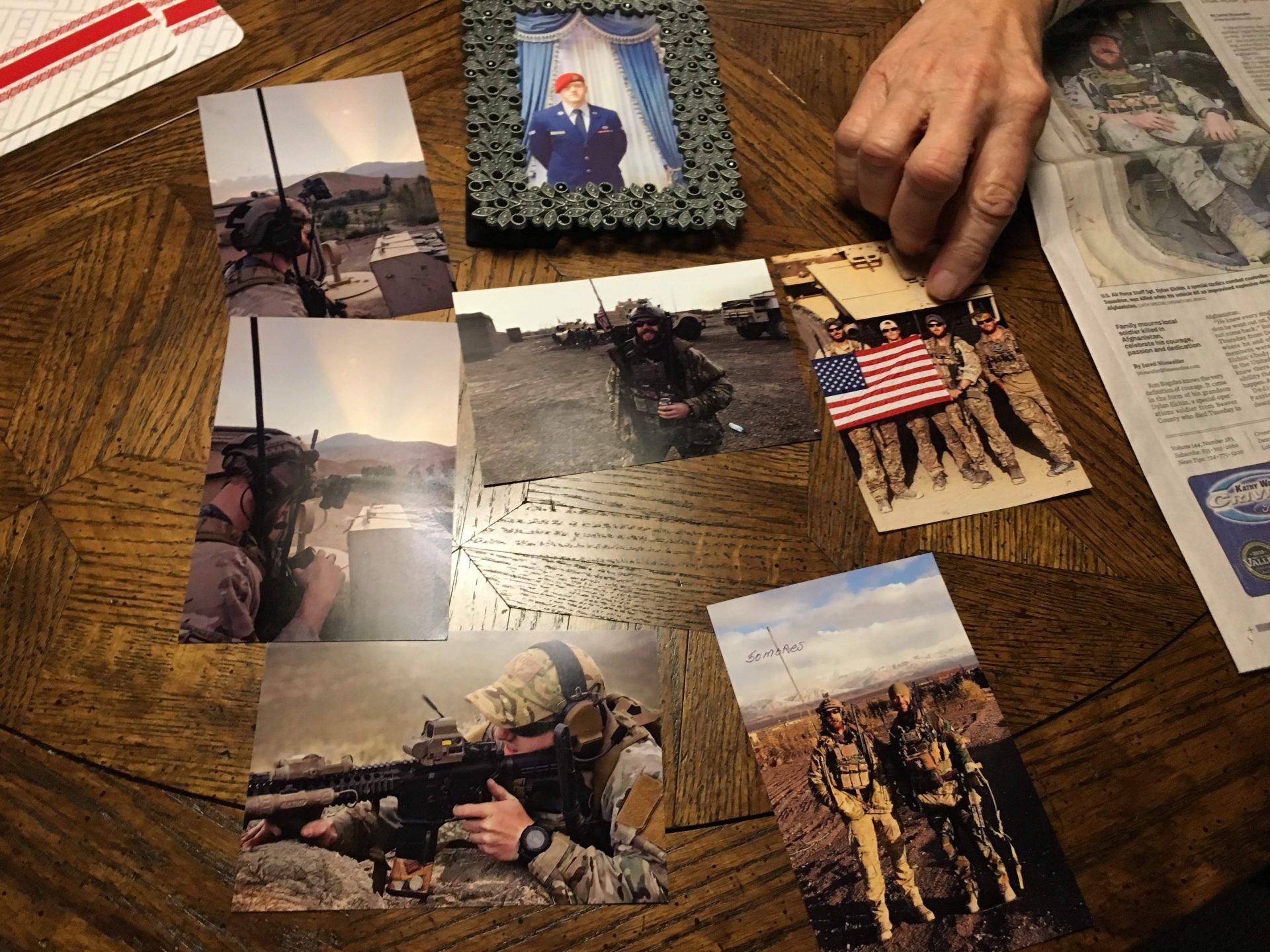 Photos of Air Force Staff Sgt. Dylan Elchin are seen on a table in the home of Ron Bogolea, Elchin's maternal grandfather, on Thursday, Dec. 13, 2018.