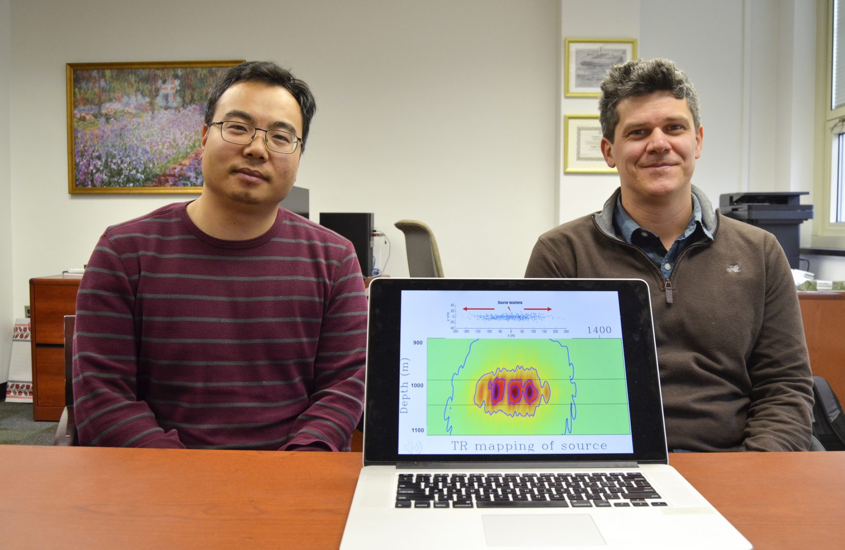 Tieyuan Zhu, left, and Eugene Morgan of Pennsylvania State University are part of a research team studying carbon storage. They are pictured here with a model that helps explain how carbon dioxide moves through rock underground.