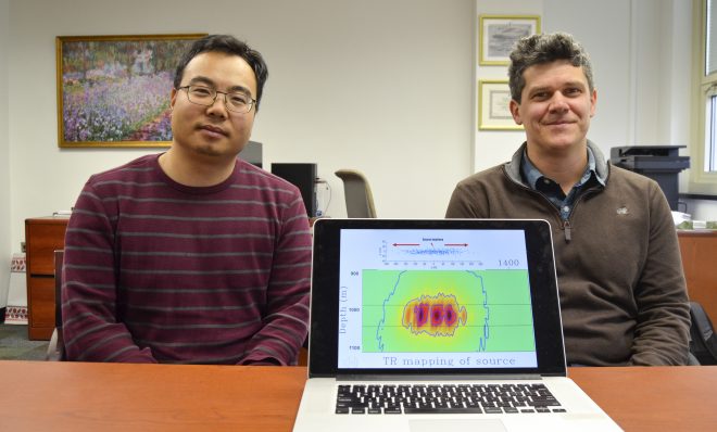 Tieyuan Zhu, left, and Eugene Morgan of Pennsylvania State University are part of a research team studying carbon storage. They are pictured here with a model that helps explain how carbon dioxide moves through rock underground.