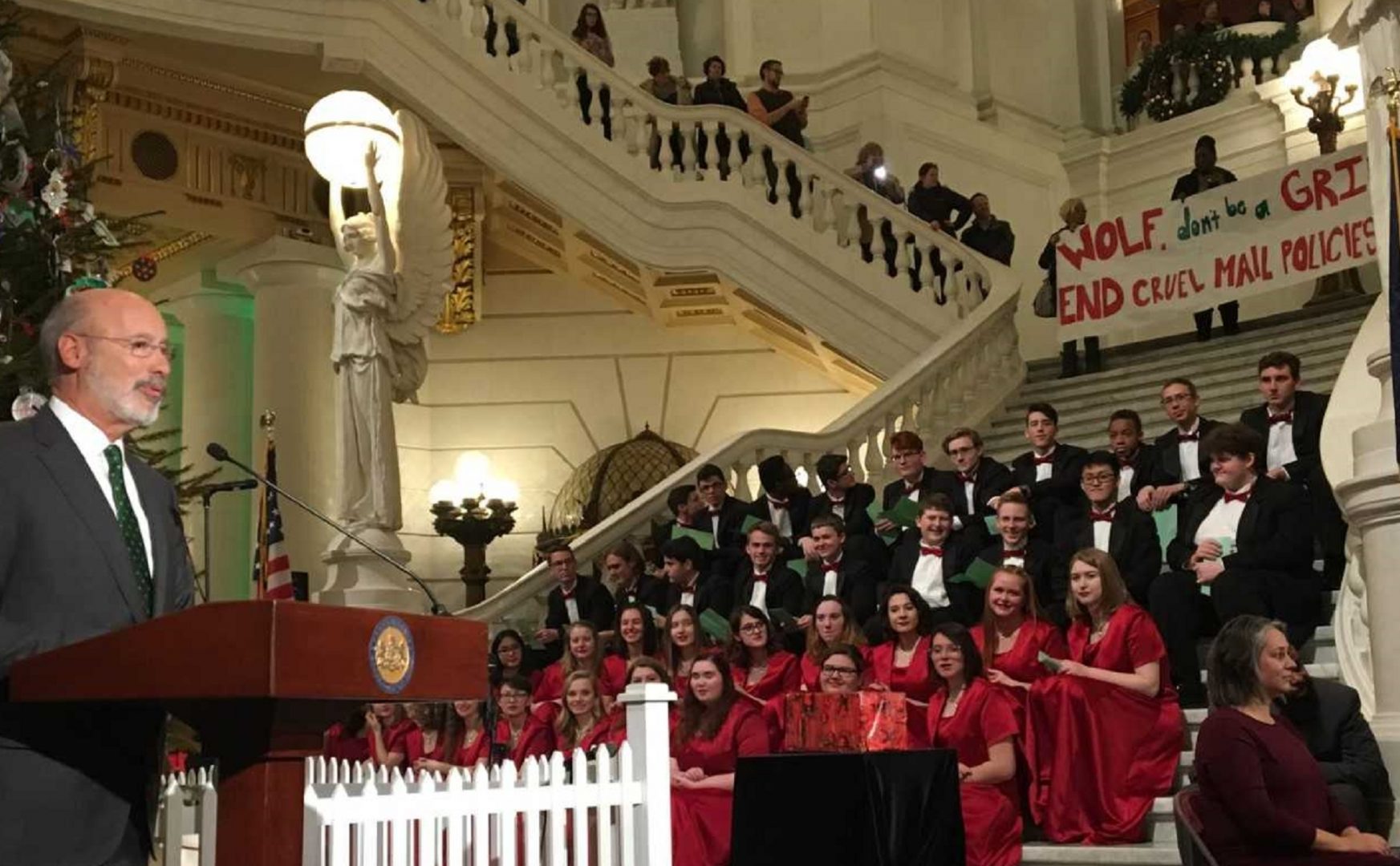 Inmate advocates interrupt Wolf’s holiday speech, plead for looser