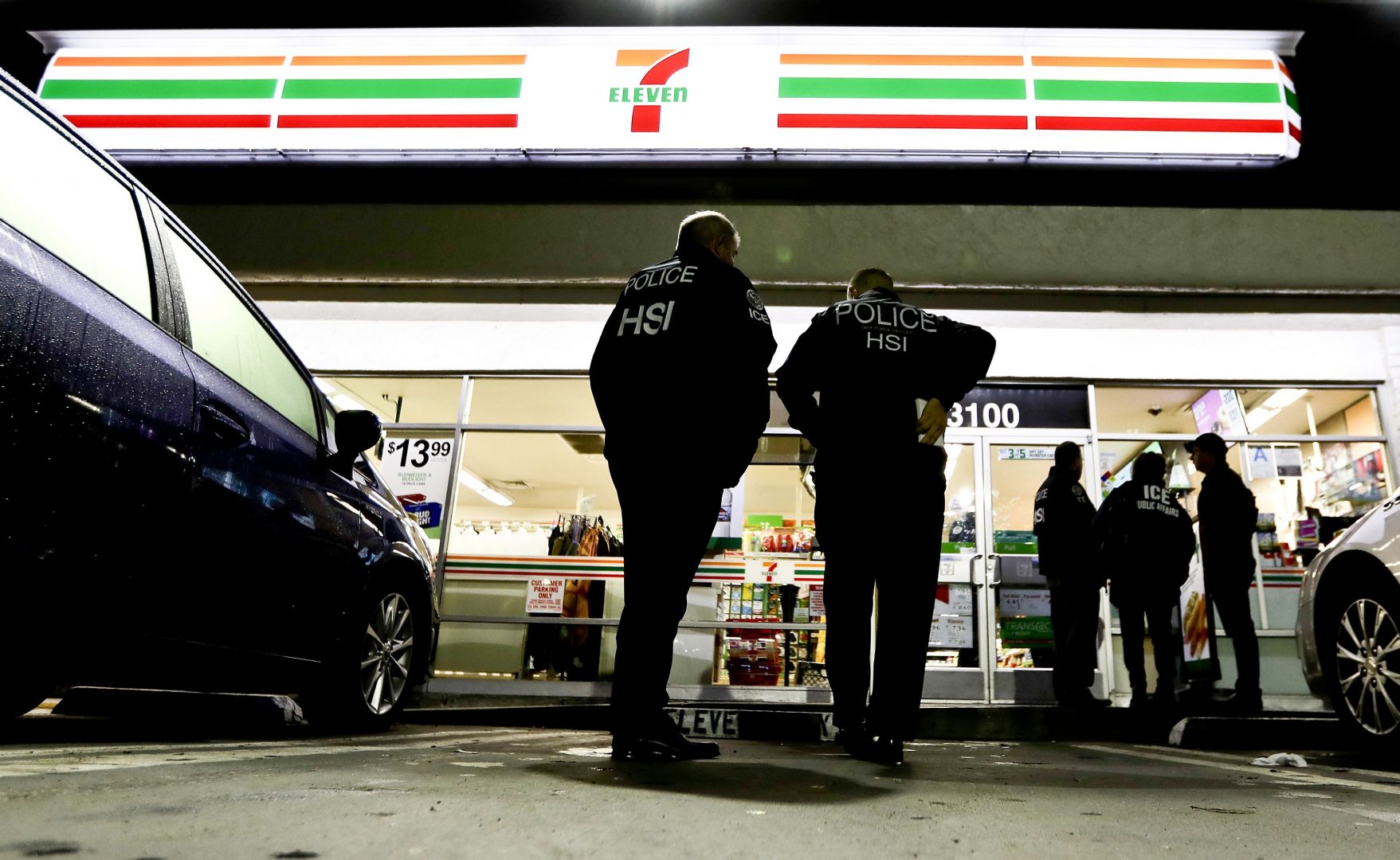 FILE - In this Jan. 10, 2018, file photo, U.S. Immigration and Customs Enforcement, ICE agents serve an employment audit notice at a 7-Eleven convenience store in Los Angeles. A federal judge has dismissed the federal government's claim that U.S. law trumps two California laws intended to protect immigrants who are in the country illegally. The ruling by U.S. District Judge John Mendez follows his ruling last week that found California was within its rights to pass two of the three sanctuary laws. He ruled Monday, July 9, 2018, that the federal government could proceed with its attempt to block part of a third California sanctuary law.