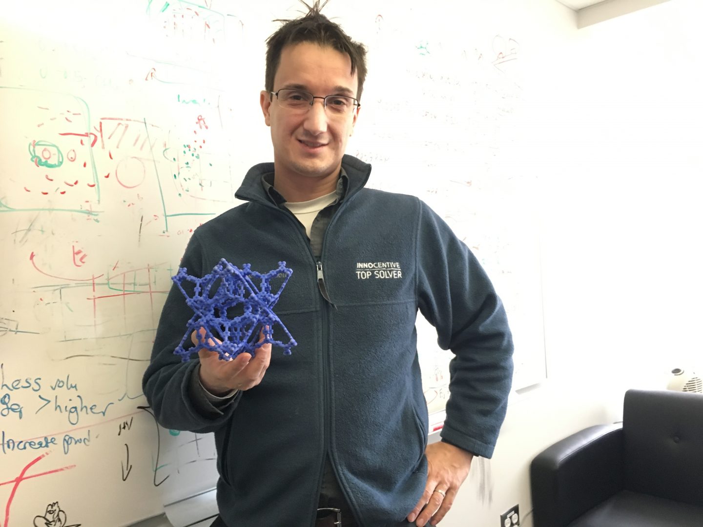 Chris Wilmer, assistant professor of chemical engineering at the University of Pittsburgh, holds a model of a metal organic framework.