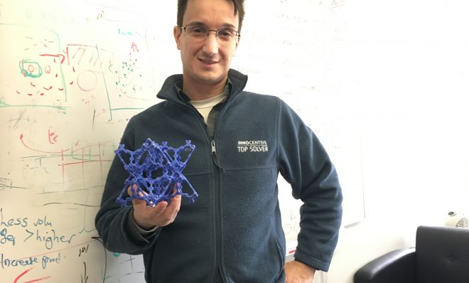 Chris Wilmer, assistant professor of chemical engineering at the University of Pittsburgh, holds a model of a metal organic framework.