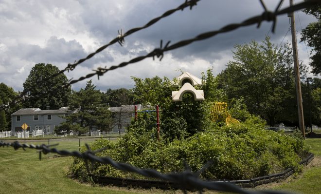 In this Aug. 1, 2018 photo weeds engulf a playground at housing section of the former Naval Air Warfare Center Warminster in Warminster, Pa. In Warminster and surrounding towns in eastern Pennsylvania, and at other sites around the United States, the foams once used routinely in firefighting training at military bases contained per-and polyfluoroalkyl substances, or PFAS. EPA testing between 2013 and 2015 found significant amounts of PFAS in public water supplies in 33 U.S. states.