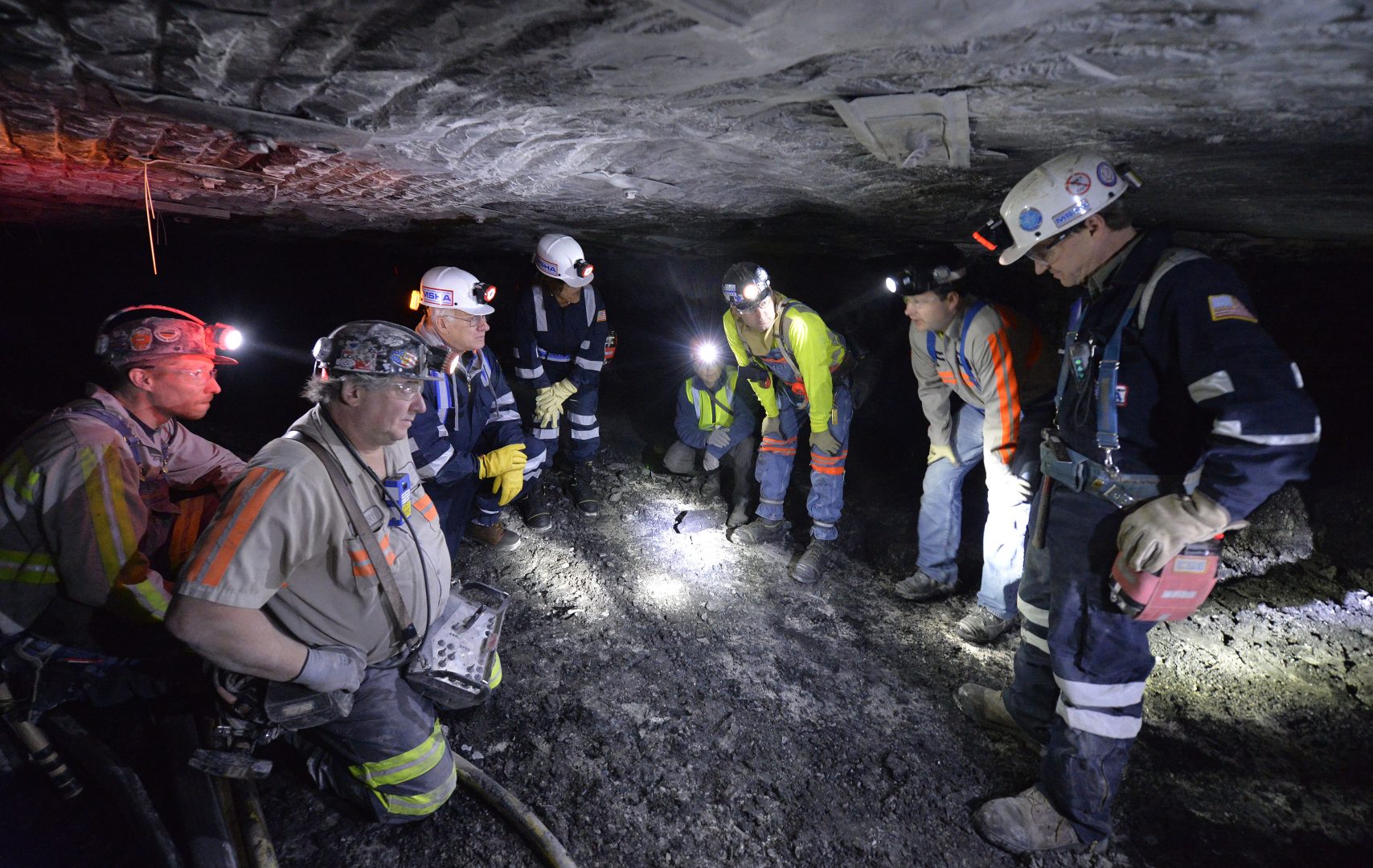In this photo, from 2015 Joe Main, third from left, Assistant Secretary of Labor for Mine Safety and Health, and Patricia Silvey, center, Deputy Assistant Secretary for Operations with MSHA, speak with workers at the Gibson North mine, in Princeton, Ind. Federal mining regulators in December 2017 indicated they were reconsidering rules meant to protect underground miners from breathing coal and rock dust - the cause of black lung - and diesel exhaust, which can cause cancer. 