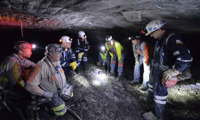 In this photo, from 2015 Joe Main, third from left, Assistant Secretary of Labor for Mine Safety and Health, and Patricia Silvey, center, Deputy Assistant Secretary for Operations with MSHA, speak with workers at the Gibson North mine, in Princeton, Ind. Federal mining regulators in December 2017 indicated they were reconsidering rules meant to protect underground miners from breathing coal and rock dust - the cause of black lung - and diesel exhaust, which can cause cancer. 