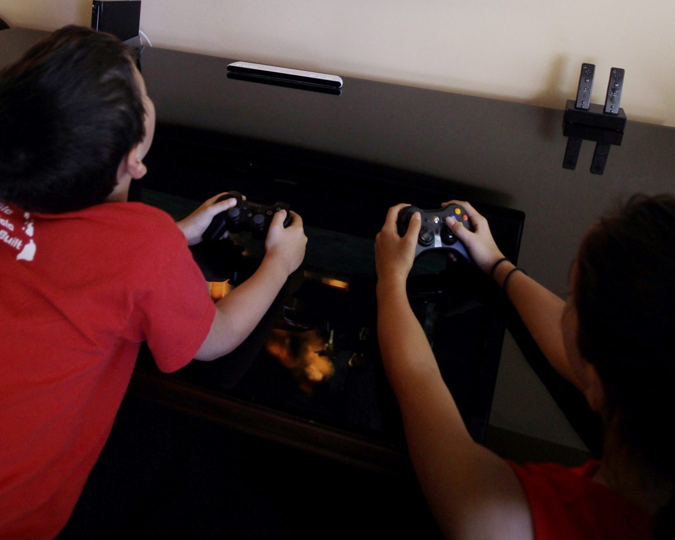 FILE PHOTO: JT Taga-Anderson, 9, left, and Mika Taga-Anderson, 13, play Grand Theft Auto IV in Los Altos, California. 