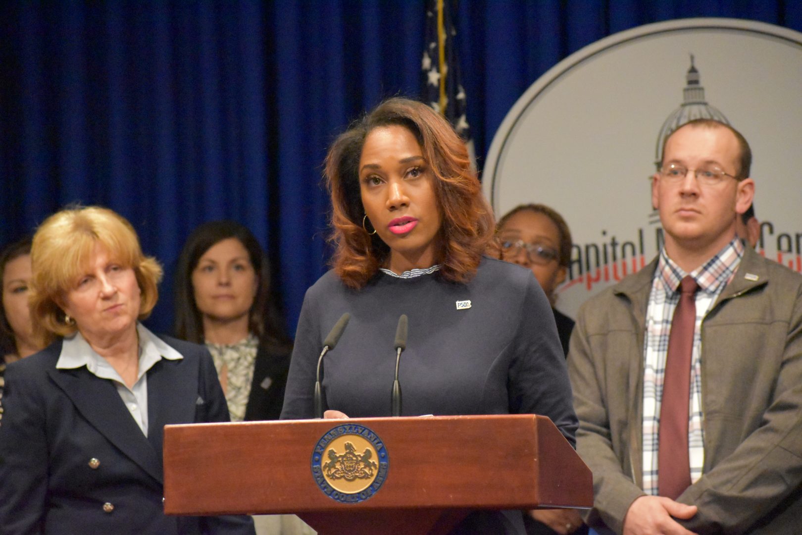 Bridgette May, a certified school nurse in the Erie City School District, speaks during a news conference at the state Capitol on March 26, 2019. 