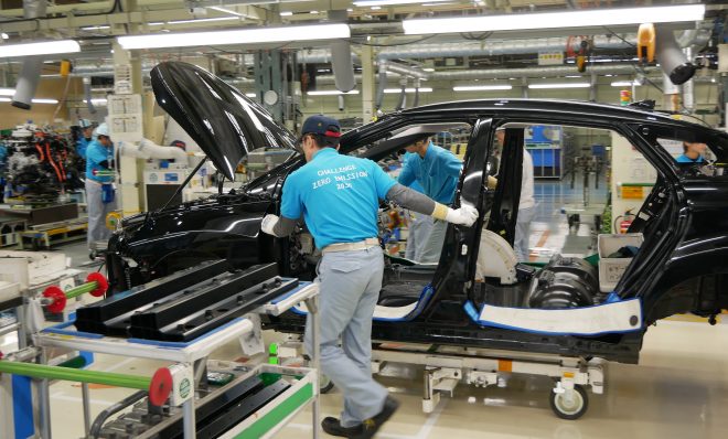 Workers push a partly assembled Mirai through the assembly line at Toyota's LFA Works in Aichi Prefecture, Japan. Since there are so few hydrogen fuel cell cars manufactured, all of them are assembled by hand. (Hiroo Saso)